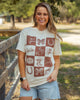 Woman wearing a t-shirt with a pattern of western brands and designs outdoors.